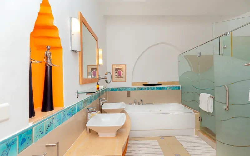 Bathroom with twin basins, a bathtub and a glass shower
